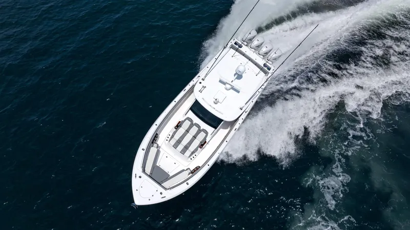 Slide: The Image of 2023 Everglades 455cc boat cruising on open water, aerial view. - 16