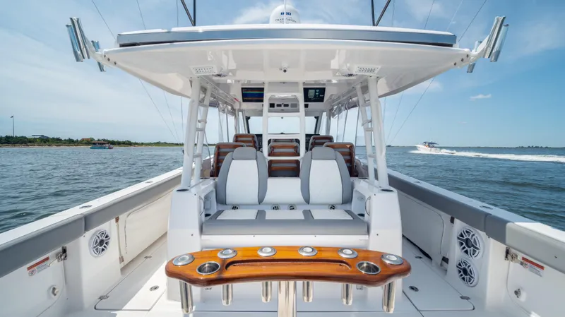 Slide: The Image of 2023 Everglades 455cc boat interior with seating and fishing rod holders. - 7