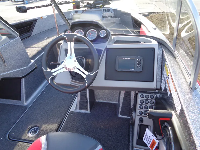 Slide: The Image of 2024 Ranger 1850 Reata boat dashboard with steering wheel and electronic display. - 10