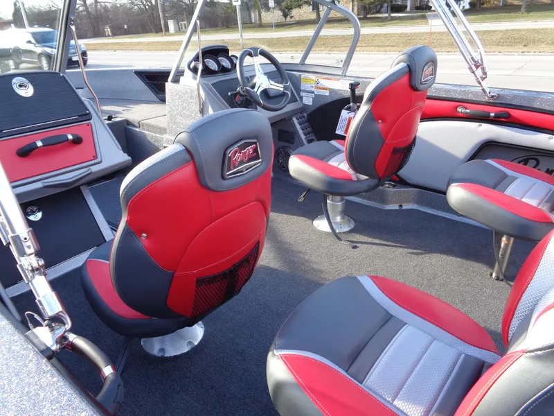 Slide: The Image of 2024 Ranger 1850 Reata boat interior with red and black seats, steering console, and dashboard. - 11