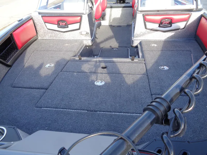 Slide: The Image of 2024 Ranger 1850 Reata boat interior with carpeted deck and red accents. - 3