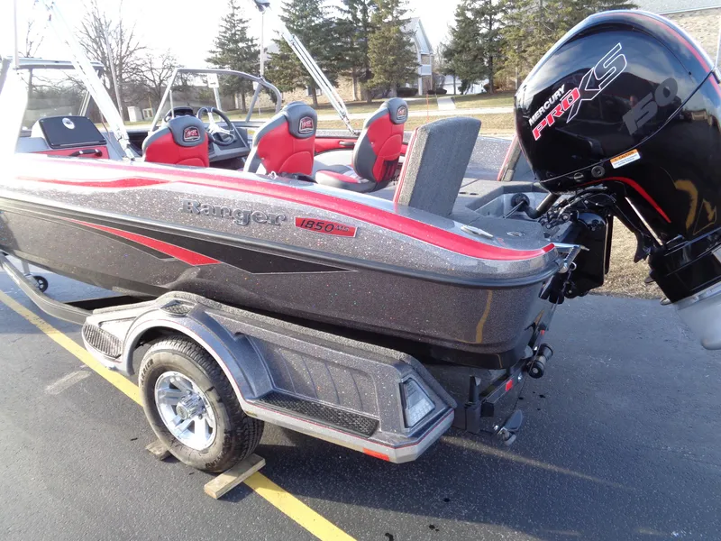 Slide: The Image of 2024 Ranger 1850 Reata boat with red and black design on a trailer. - 6