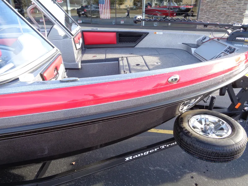 Slide: The Image of 2024 Ranger 1850 Reata boat with red and black exterior on a trailer. - 7
