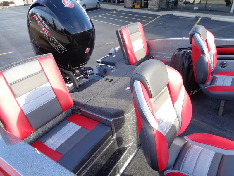 Slide: The Image of 2024 Ranger 1850 Reata boat interior with red and gray seats and motor. - 9