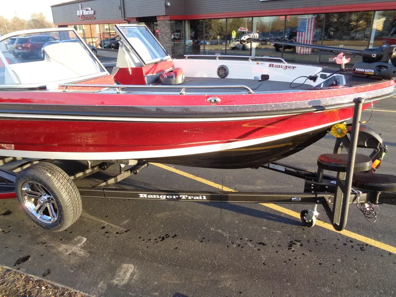 Slide: The Image of 2024 Ranger 621 FS PRO boat on Ranger Trail trailer, parked outside dealership. - 10