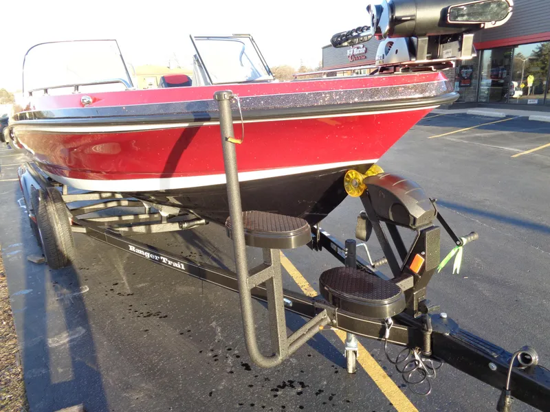 Slide: The Image of 2024 Ranger 621 FS PRO boat on trailer, red and black exterior. - 11
