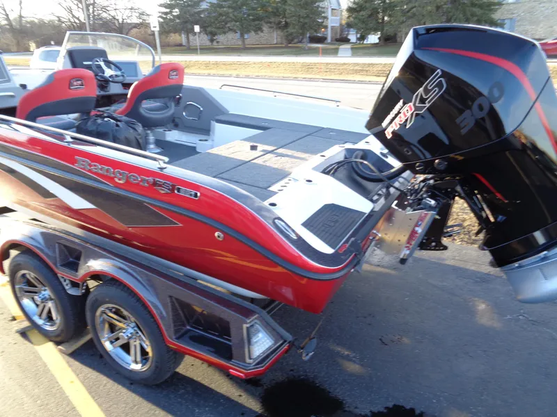 Slide: The Image of 2024 Ranger 621 FS PRO boat with dual seats and powerful outboard motor. - 13