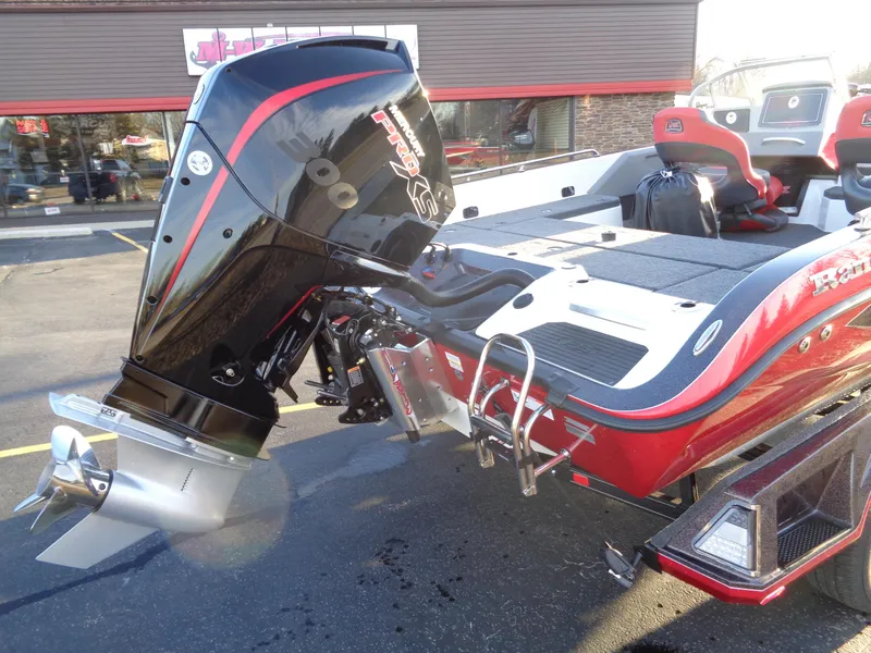 Slide: The Image of 2024 Ranger 621 FS PRO boat with powerful outboard motor in parking lot. - 18