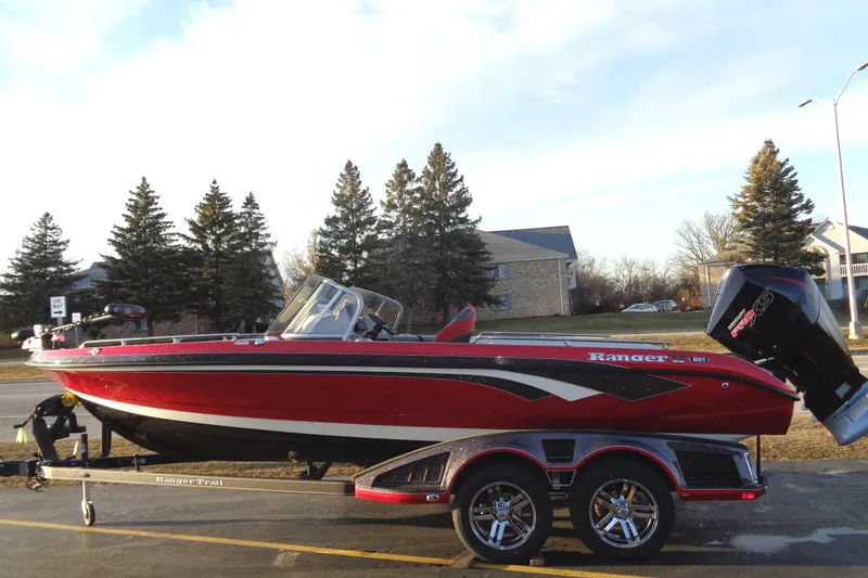 Slide: The Image of 2024 Ranger 621 FS PRO boat on trailer, red and black, side view. - 2