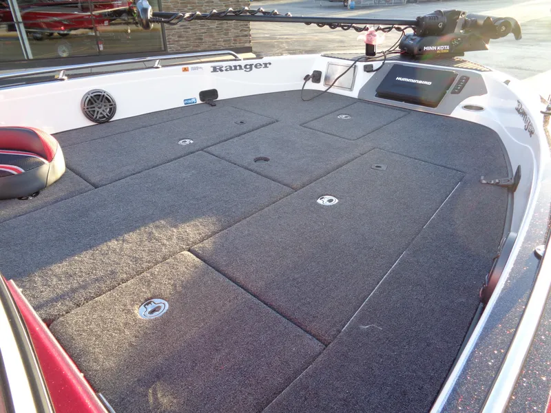 Slide: The Image of 2024 Ranger 621 FS PRO boat deck with storage compartments and fishing equipment. - 22