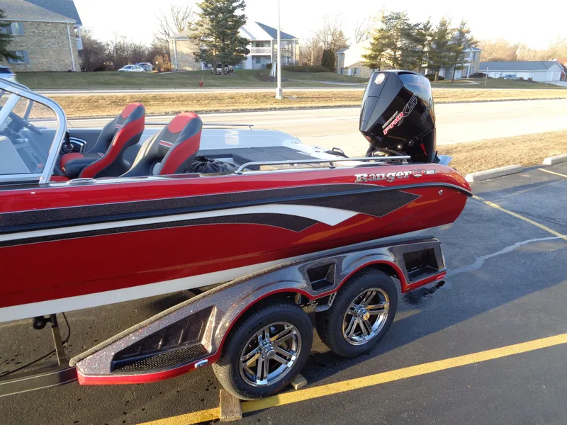 Slide: The Image of 2024 Ranger 621 FS PRO boat with red and black design on a trailer. - 24
