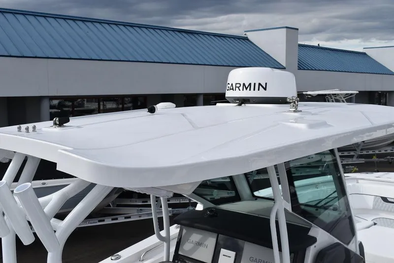 Slide: The Image of 2024 Blackfin 272CC boat with Garmin radar, white hardtop, and modern design. - 12