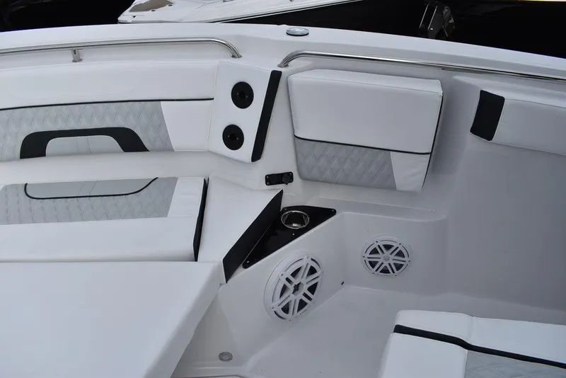 Slide: The Image of 2024 Blackfin 272CC boat interior with white cushioned seating and built-in speakers. - 21