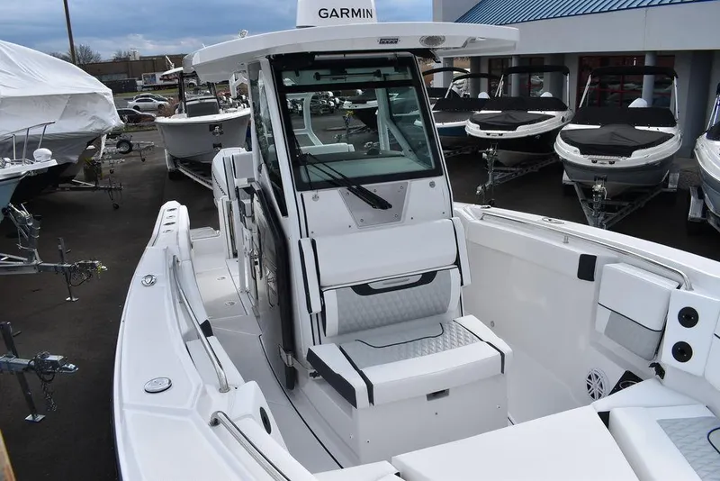 Slide: The Image of 2024 Blackfin 272CC center console boat with Garmin electronics, docked at a marina. - 24