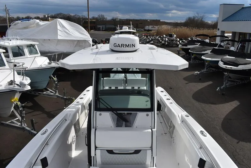 Slide: The Image of 2024 Blackfin 272CC boat with Garmin navigation system in a marina. - 29