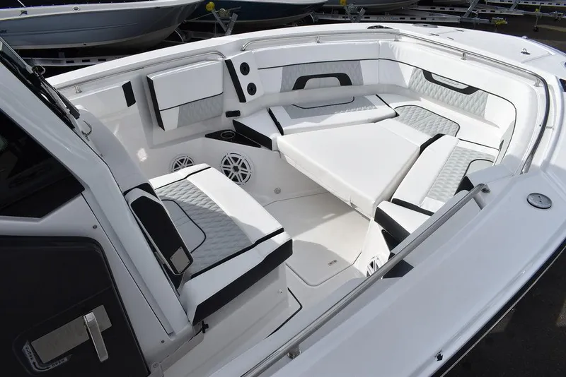 Slide: The Image of 2024 Blackfin 272CC boat interior with cushioned seating and modern design. - 30