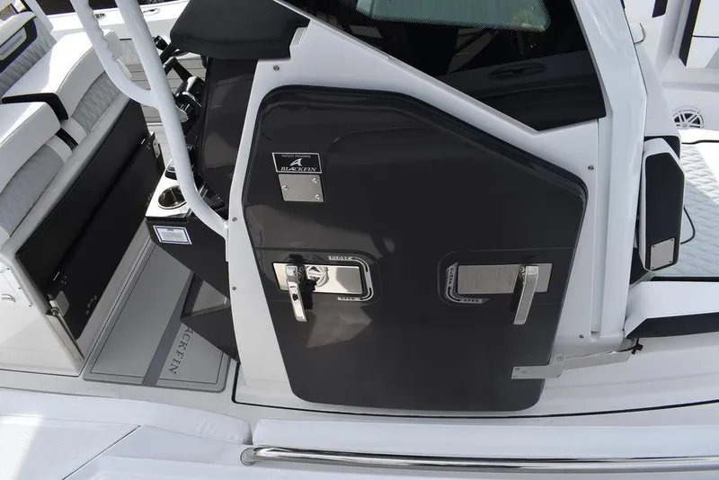 Slide: The Image of 2024 Blackfin 272CC boat interior with black console and seating. - 31