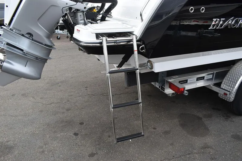 Slide: The Image of 2024 Blackfin 272CC boat with ladder and outboard motor on trailer. - 32