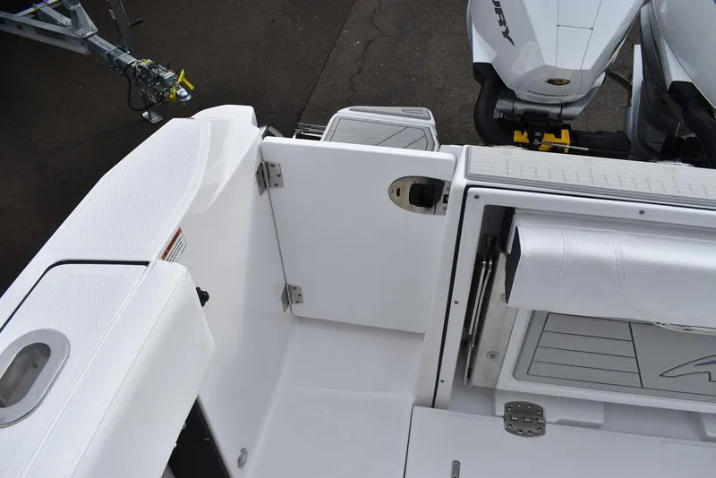Slide: The Image of 2024 Blackfin 272CC boat interior with open transom door and seating. - 34