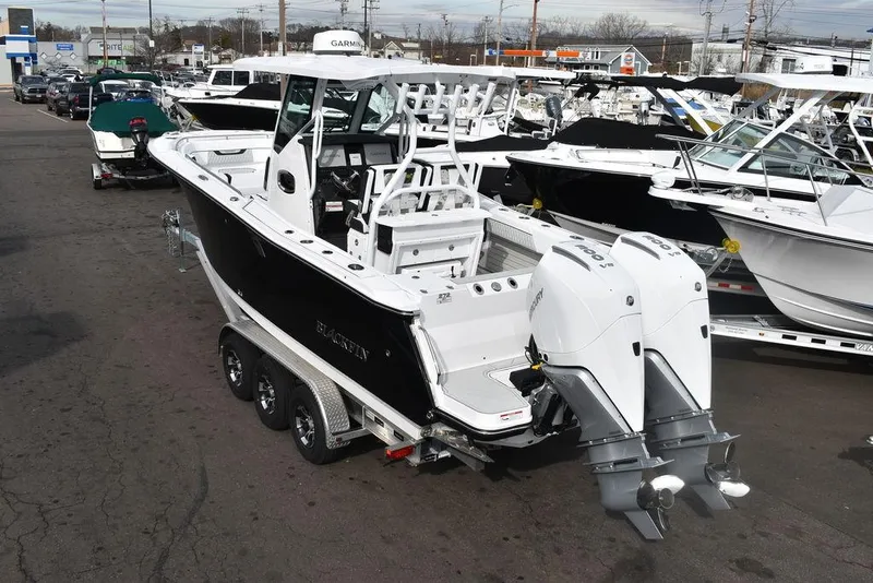 Slide: The Image of 2024 Blackfin 272CC boat with dual outboard engines on a trailer. - 4