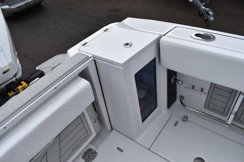 Slide: The Image of 2024 Blackfin 272CC boat interior, featuring storage compartments and sleek white design. - 41