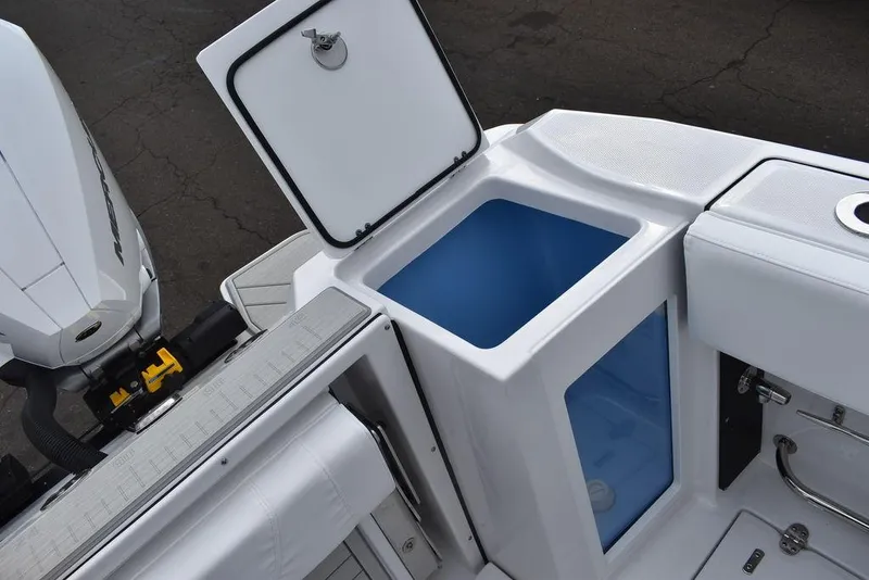 Slide: The Image of 2024 Blackfin 272CC boat with open storage compartment and outboard motor. - 42