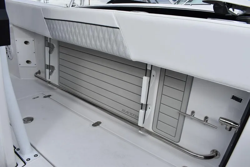 Slide: The Image of 2024 Blackfin 272CC boat interior storage compartment with stainless steel rail. - 48