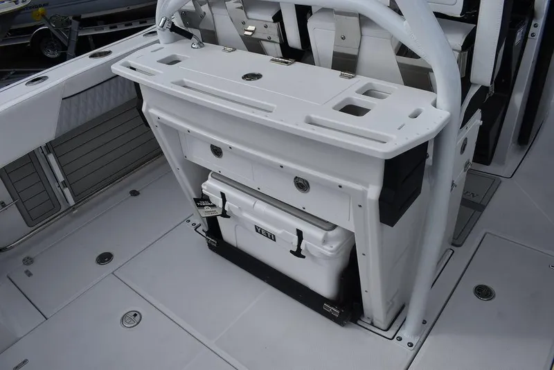 Slide: The Image of 2024 Blackfin 272CC boat deck with Yeti cooler and storage compartments. - 49