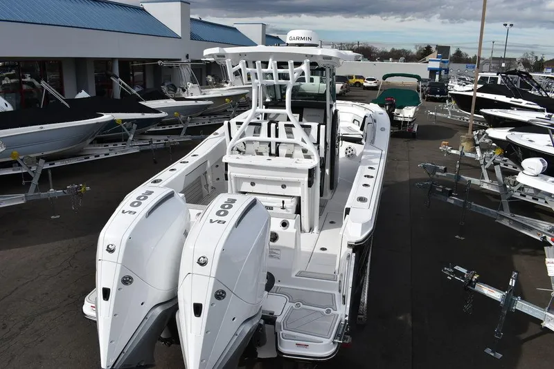 Slide: The Image of 2024 Blackfin 272CC boat with twin outboard engines at a dealership. - 6