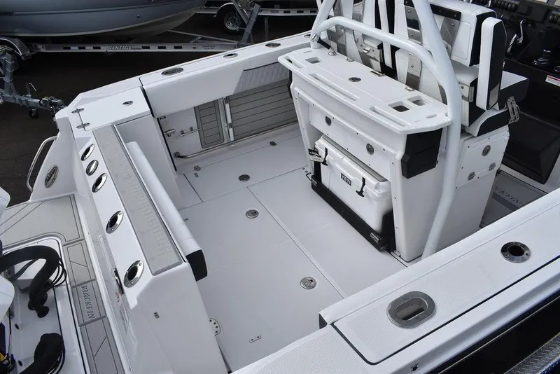 Slide: The Image of 2024 Blackfin 272CC boat interior, spacious deck with seating and storage. - 8