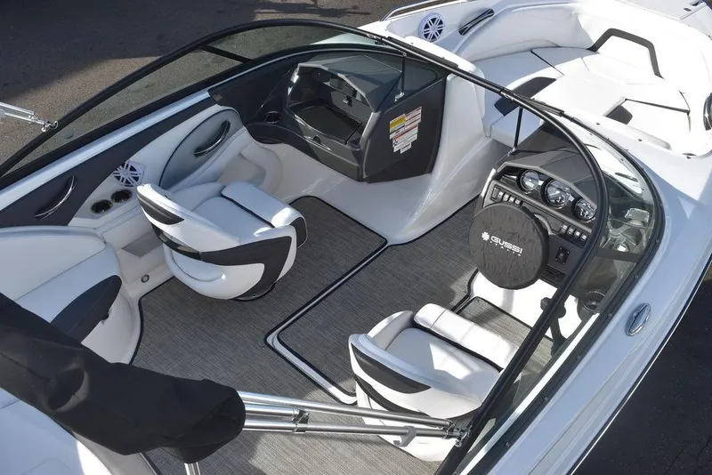 Slide: The Image of 2024 Monterey 224FS boat interior with white and black seating, dashboard, and steering wheel. - 10
