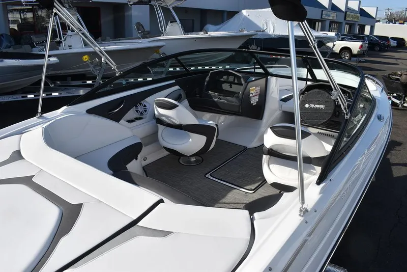 Slide: The Image of 2024 Monterey 224FS boat interior with white and black seating, dashboard, and steering wheel. - 12