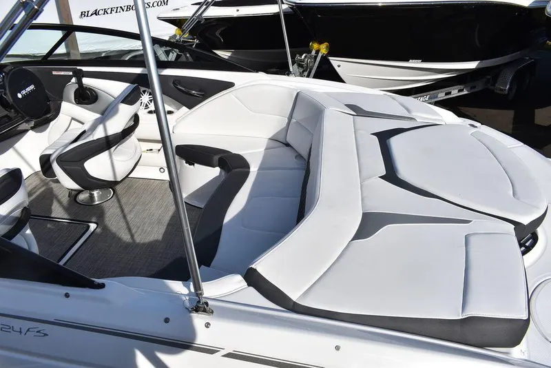 Slide: The Image of 2024 Monterey 224FS boat interior with white and black seating. - 13