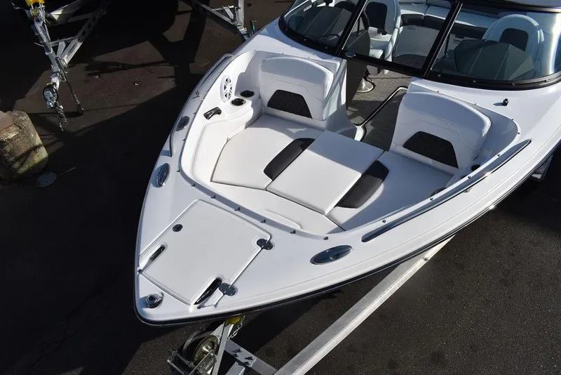Slide: The Image of 2024 Monterey 224FS boat, white exterior, bow seating area, on trailer. - 16