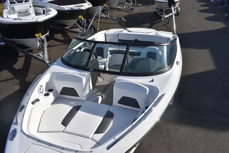 Slide: The Image of 2024 Monterey 224FS boat with white and gray interior, docked among other boats. - 17