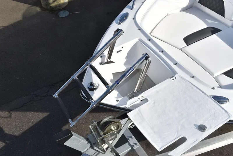 Slide: The Image of 2024 Monterey 224FS boat with extended ladder and seating area. - 18