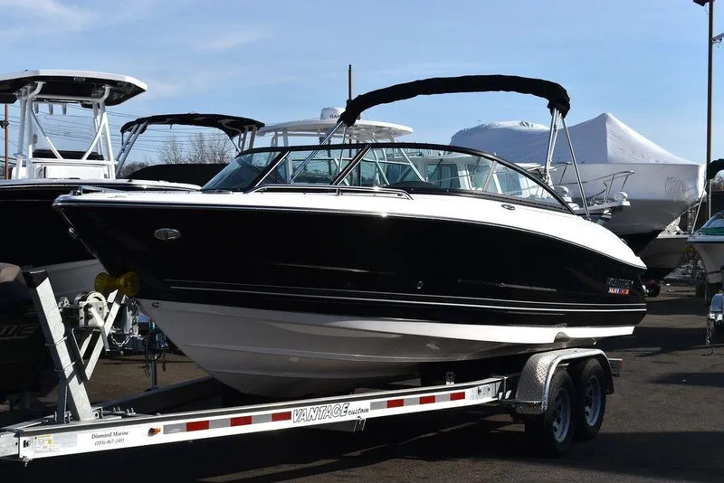Slide: The Image of 2024 Monterey 224FS boat on a trailer in a marina. - 2