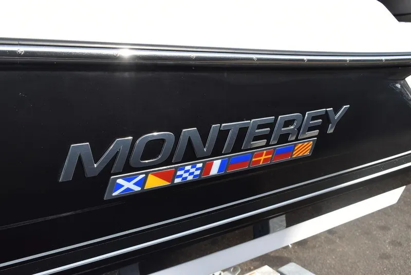 Slide: The Image of 2024 Monterey 224FS boat logo with nautical flags on black hull. - 21
