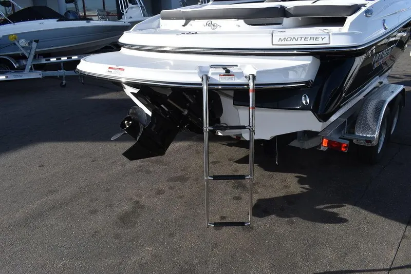 Slide: The Image of 2024 Monterey 224FS boat rear view with ladder and trailer. - 22