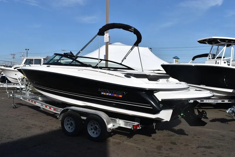 Slide: The Image of 2024 Monterey 224FS boat on a trailer, black and white exterior, displayed outdoors. - 3