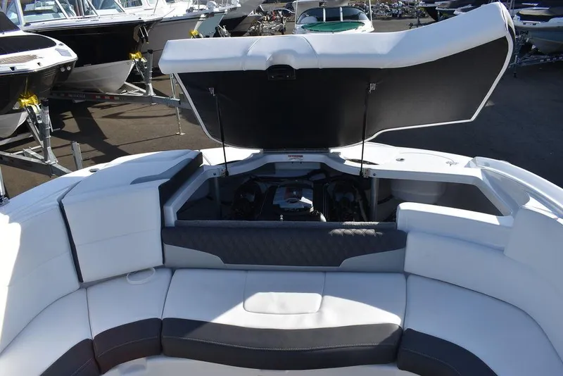 Slide: The Image of 2024 Monterey 224FS boat with open engine compartment and white seating. - 32