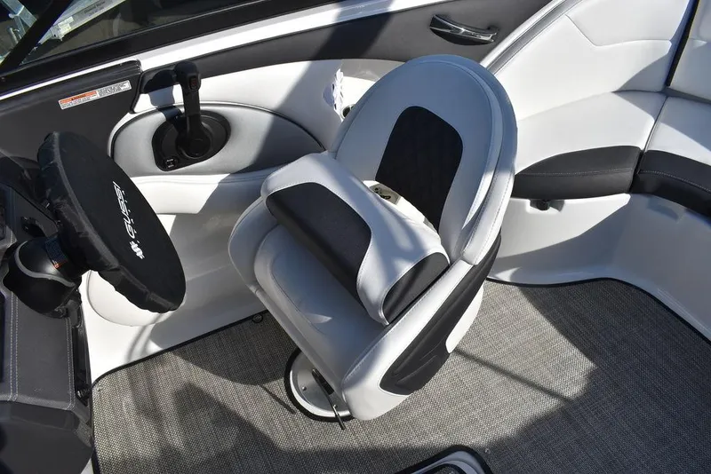 Slide: The Image of 2024 Monterey 224FS boat interior with captain's chair and steering wheel. - 46