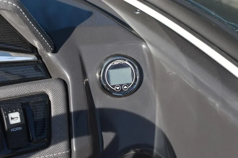 Slide: The Image of 2024 Monterey 224FS boat dashboard with depth gauge and horn button. - 48