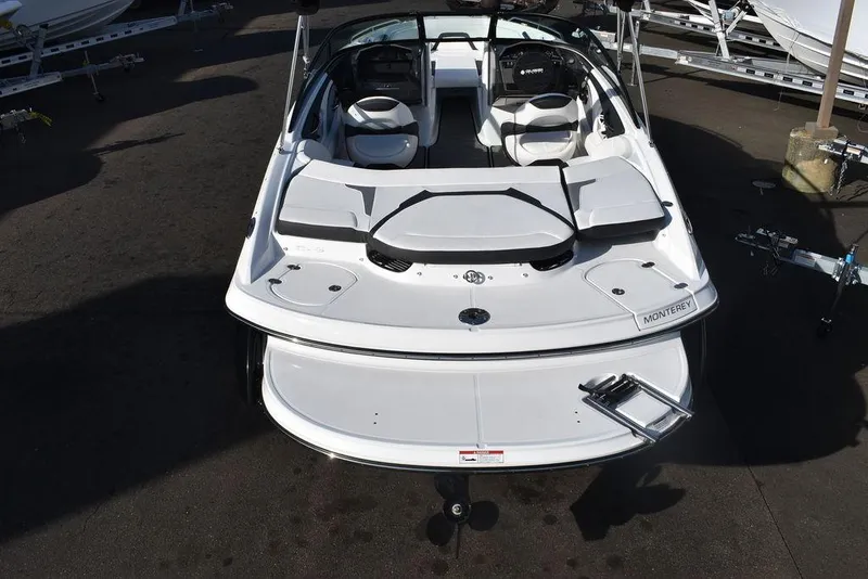 Slide: The Image of 2024 Monterey 224FS boat, rear view, white exterior, docked. - 5
