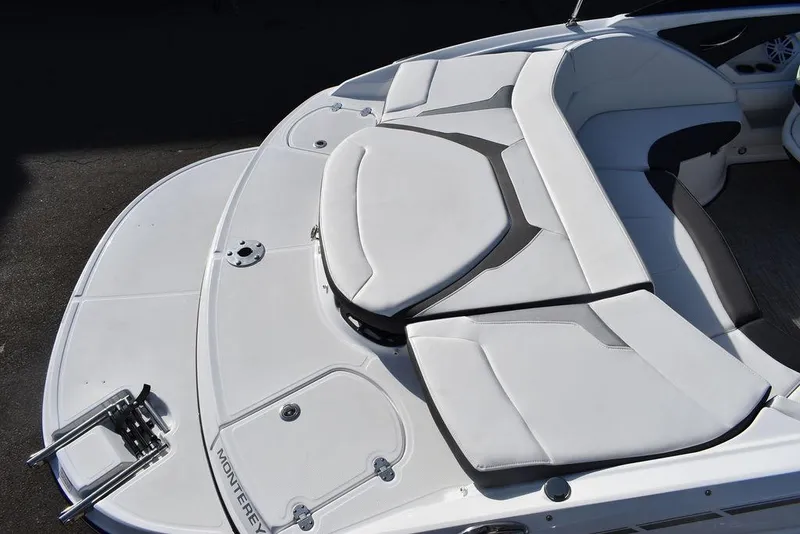 Slide: The Image of 2024 Monterey 224FS boat with white cushioned seating and swim platform. - 7