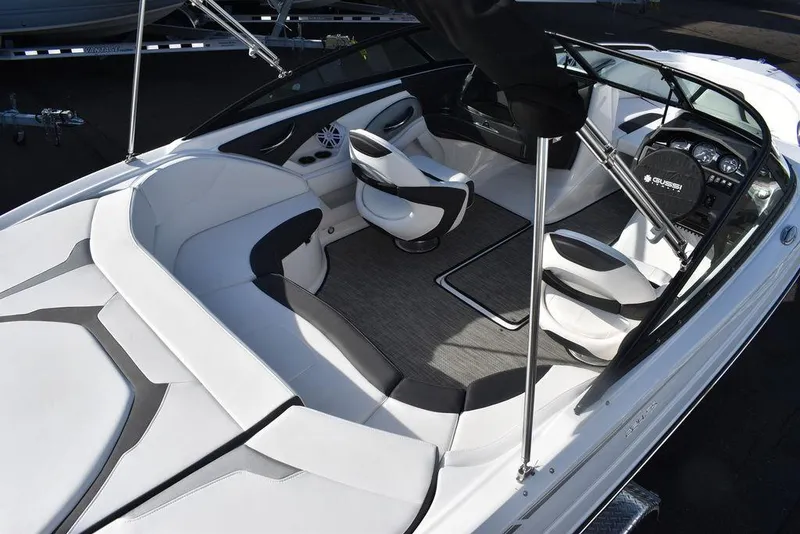 Slide: The Image of 2024 Monterey 224FS boat interior with white and gray seating, steering wheel, and dashboard. - 8