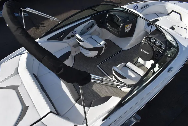 Slide: The Image of 2024 Monterey 224FS boat interior with white and black seating, steering console, and modern design. - 9