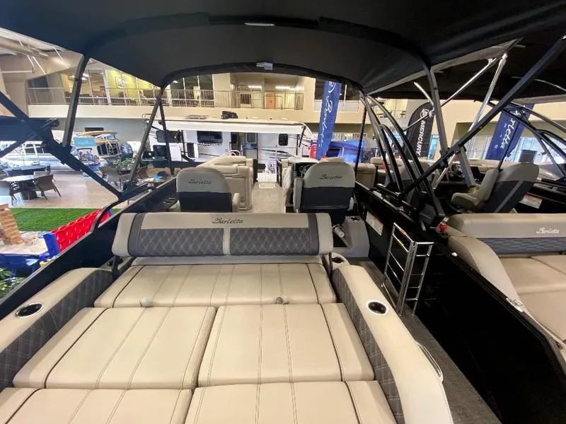 Slide: The Image of 2024 Barletta Lusso Ultra-Lounge L25U luxury pontoon boat interior at a showroom. - 7