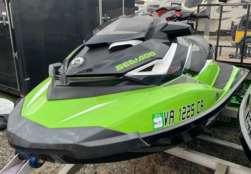 Slide: The Image of 2017 Bombardier Sea Doo GTR 230 jet ski, green and black, on a trailer. - 14