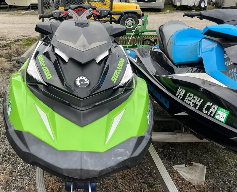Slide: The Image of 2017 Bombardier Sea Doo GTR 230 jet ski, green and black, parked on a trailer. - 15